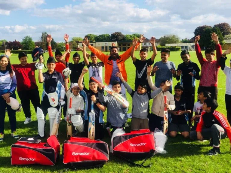 Spikes Bridge Junior CC young cricket players celebrating outdoors